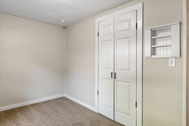 741 N Warren Ave, Springfield, MO 65802 - unfurnished bedroom featuring carpet flooring, baseboards, a textured ceiling, and a closet