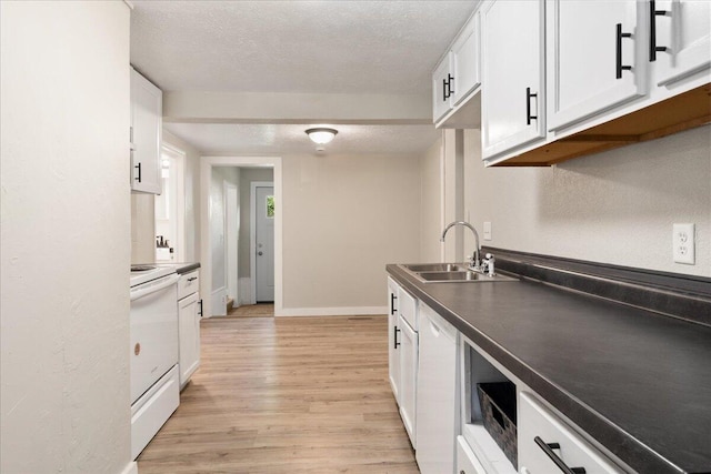 741 N Warren Ave, Springfield, MO 65802 - kitchen with electric range, a sink, a textured ceiling, white cabinetry, and light wood-style flooring