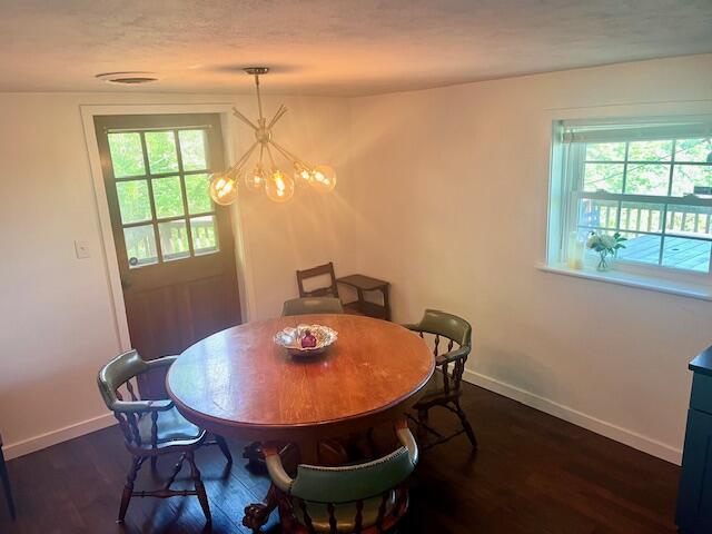 530 Taneycomo Hill Dr, Hollister, MO 65672 - dining room with a chandelier, dark wood-style flooring, and baseboards