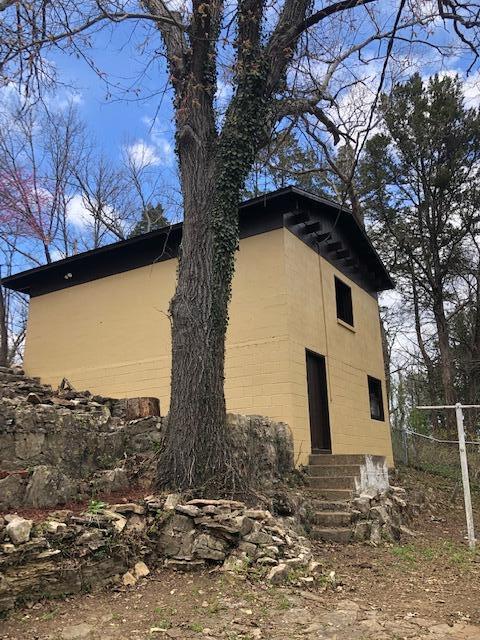 530 Taneycomo Hill Dr, Hollister, MO 65672 - view of side of home with entry steps and concrete block siding