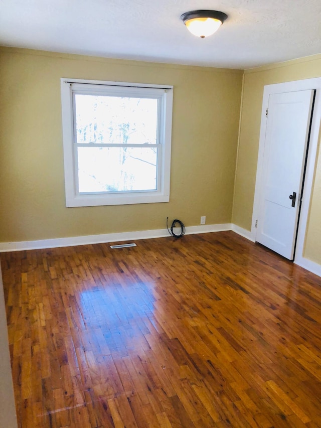 530 Taneycomo Hill Dr, Hollister, MO 65672 - unfurnished room with dark wood-style floors, ornamental molding, and baseboards