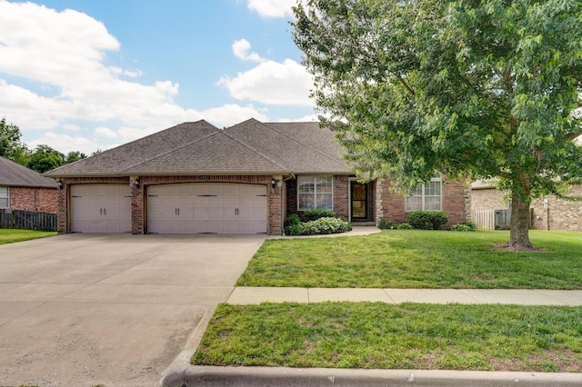 4353 S Frisco Trails Rd, Springfield, MO 65810 - view of front facade with a garage, concrete driveway, a shingled roof, and brick siding