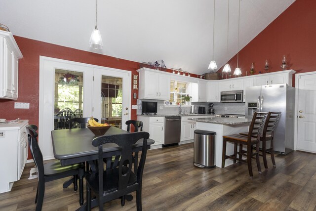 150 Licaria Rd, Ozark, MO 65721 - kitchen with stainless steel appliances, white cabinets, backsplash, dark wood finished floors, and plenty of natural light