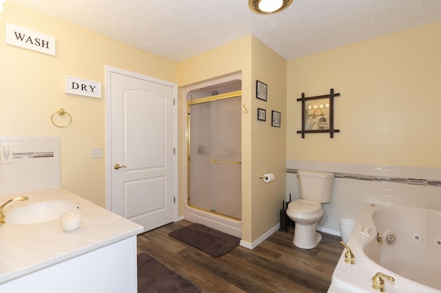 150 Licaria Rd, Ozark, MO 65721 - bathroom featuring wood finished floors, a stall shower, a tub with jets, a textured ceiling, and vanity