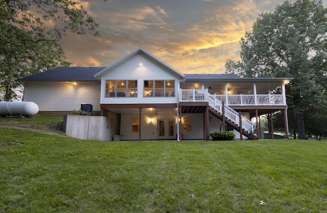 150 Licaria Rd, Ozark, MO 65721 - back of house at dusk with stairway, a wooden deck, french doors, and a yard