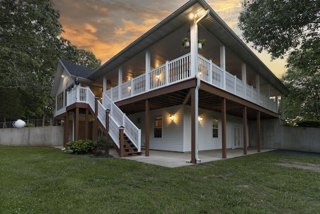 150 Licaria Rd, Ozark, MO 65721 - back of house at dusk featuring a yard, a patio, a wooden deck, and stairway