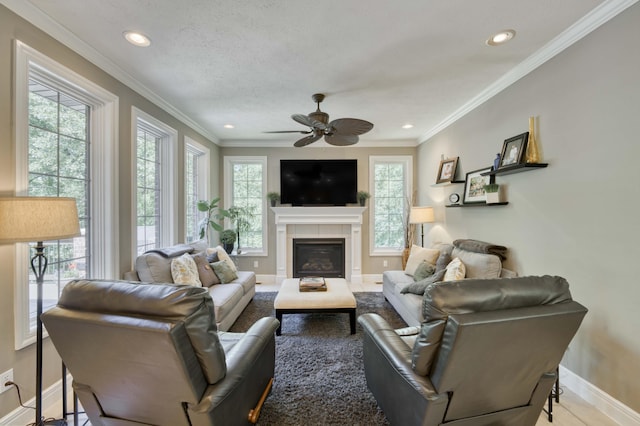 3262 S Thornridge Dr, Springfield, MO 65809 - living area featuring ceiling fan, baseboards, recessed lighting, a tiled fireplace, and crown molding