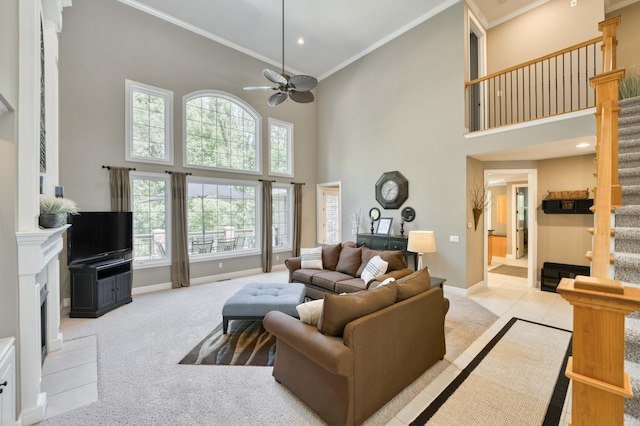 3262 S Thornridge Dr, Springfield, MO 65809 - carpeted living area with stairs, a high ceiling, crown molding, a fireplace, and a ceiling fan