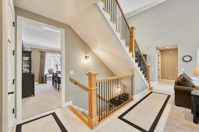 3262 S Thornridge Dr, Springfield, MO 65809 - stairway featuring tile patterned flooring, baseboards, and vaulted ceiling