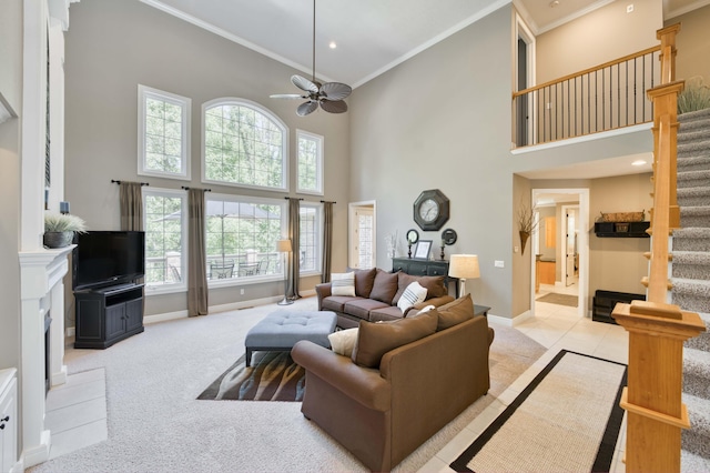 3262 S Thornridge Dr, Springfield, MO 65809 - living area featuring stairs, a towering ceiling, crown molding, ceiling fan, and baseboards