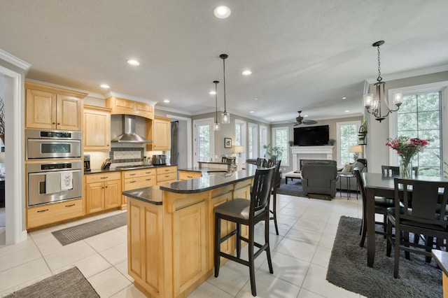 3262 S Thornridge Dr, Springfield, MO 65809 - kitchen featuring light brown cabinetry, wall chimney range hood, crown molding, double oven, and dark countertops