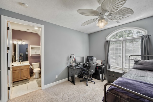 3262 S Thornridge Dr, Springfield, MO 65809 - bedroom with an office area, ensuite bath, light carpet, a sink, and baseboards