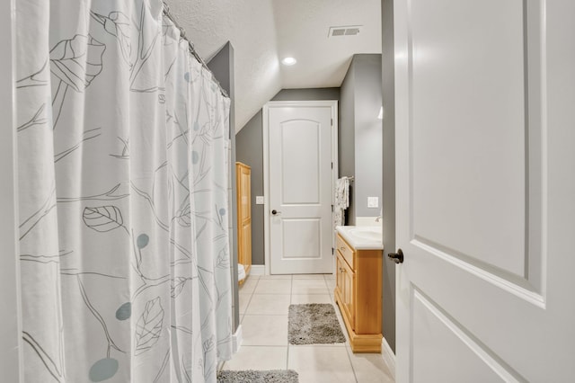 3262 S Thornridge Dr, Springfield, MO 65809 - bathroom with vanity, tile patterned flooring, baseboards, a textured ceiling, and a shower with curtain