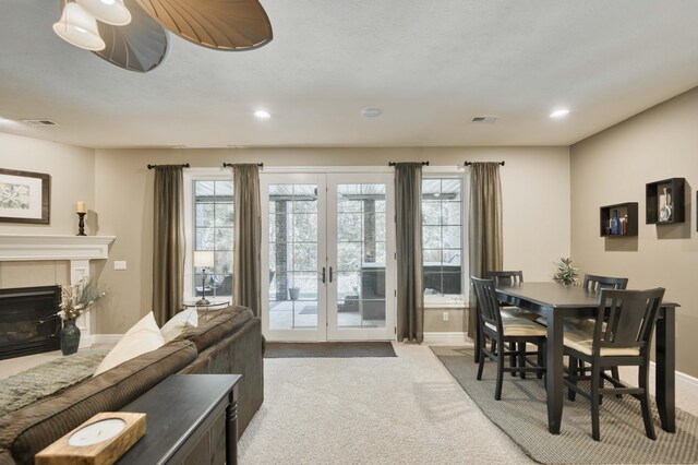 3262 S Thornridge Dr, Springfield, MO 65809 - dining space with carpet floors, french doors, baseboards, recessed lighting, and a fireplace with flush hearth