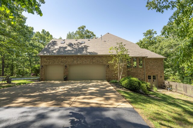 3262 S Thornridge Dr, Springfield, MO 65809 - view of front of home featuring brick siding, concrete driveway, a garage, and roof with shingles