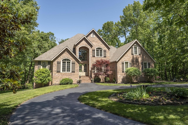 3262 S Thornridge Dr, Springfield, MO 65809 - traditional-style home with brick siding, a front lawn, curved driveway, and a shingled roof