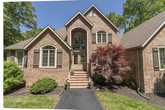 3262 S Thornridge Dr, Springfield, MO 65809 - traditional-style house with brick siding, roof with shingles, and french doors