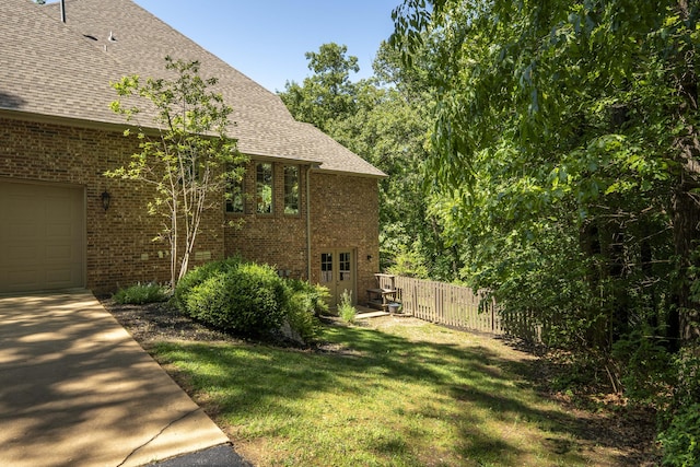 3262 S Thornridge Dr, Springfield, MO 65809 - view of property exterior with brick siding, roof with shingles, and a garage