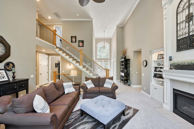 3262 S Thornridge Dr, Springfield, MO 65809 - living room featuring a high ceiling, a ceiling fan, stairs, crown molding, and built in shelves