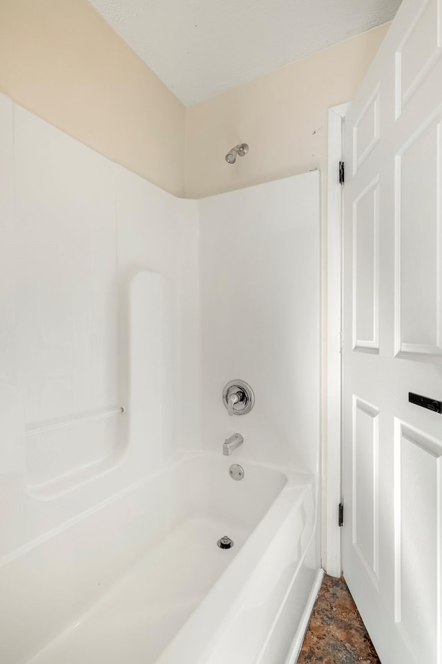 332 E Silsby St, Springfield, MO 65807 - bathroom featuring  shower combination and stone finish floors