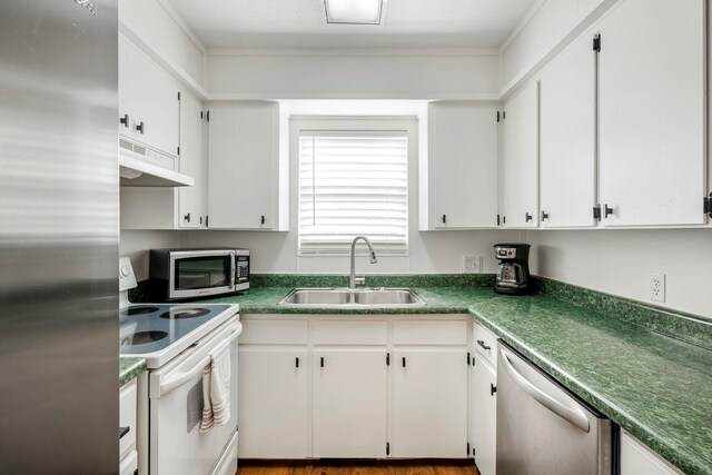 332 E Silsby St, Springfield, MO 65807 - kitchen with stainless steel appliances, under cabinet range hood, a sink, white cabinetry, and dark countertops