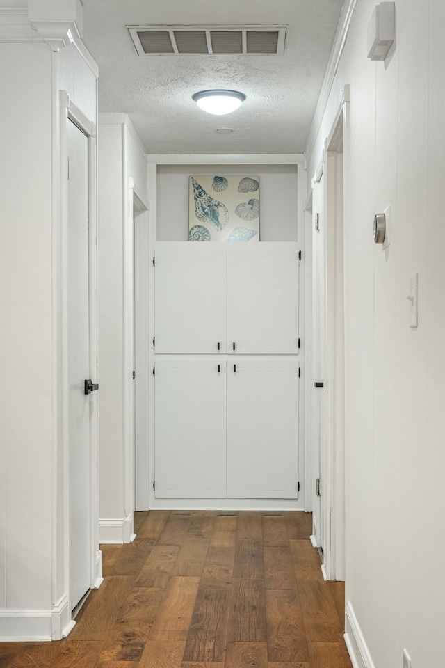 332 E Silsby St, Springfield, MO 65807 - corridor featuring a textured ceiling, baseboards, and dark wood-style floors