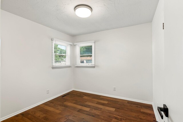 332 E Silsby St, Springfield, MO 65807 - empty room featuring baseboards and dark wood finished floors