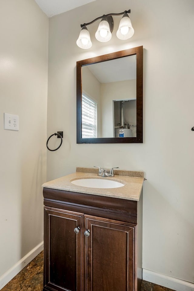 332 E Silsby St, Springfield, MO 65807 - bathroom with baseboards, vanity, and stone finish floors