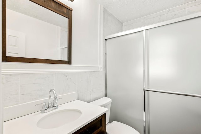 332 E Silsby St, Springfield, MO 65807 - bathroom with toilet, tile walls, vanity, an enclosed shower, and a textured ceiling