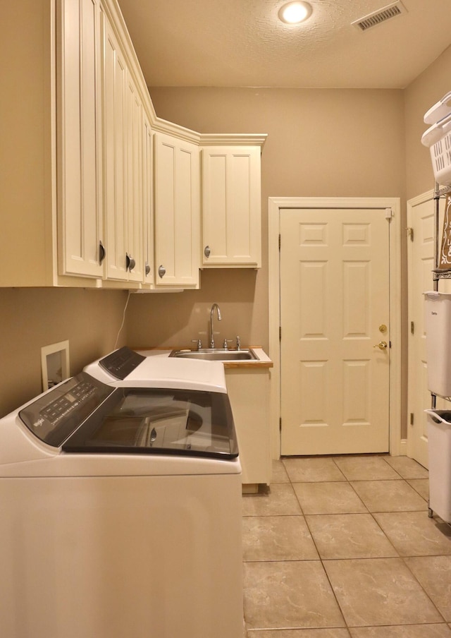 607 Sumac Ln, Marshfield, MO 65706 - laundry area with washing machine and clothes dryer, cabinet space, and light tile patterned floors