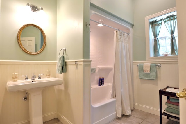 607 Sumac Ln, Marshfield, MO 65706 - bathroom with a wainscoted wall, tile patterned flooring, shower / bath combo with shower curtain, and a sink