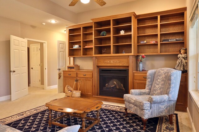 607 Sumac Ln, Marshfield, MO 65706 - living area featuring baseboards, a ceiling fan, a fireplace, and light colored carpet
