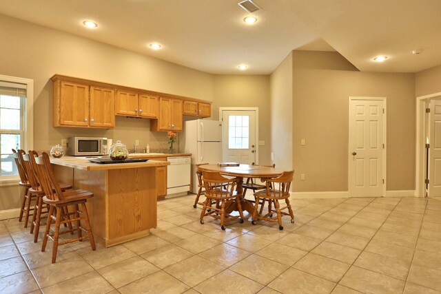 607 Sumac Ln, Marshfield, MO 65706 - kitchen featuring white appliances, baseboards, light countertops, a peninsula, and light tile patterned floors