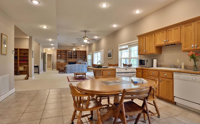 607 Sumac Ln, Marshfield, MO 65706 - kitchen featuring dishwasher, stainless steel microwave, a fireplace, light carpet, and a ceiling fan