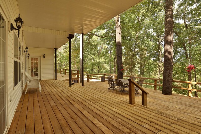 607 Sumac Ln, Marshfield, MO 65706 - wooden terrace featuring outdoor dining area and view of wooded area