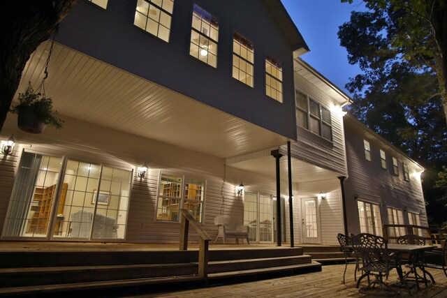 607 Sumac Ln, Marshfield, MO 65706 - back of house at night with a porch and outdoor dining area