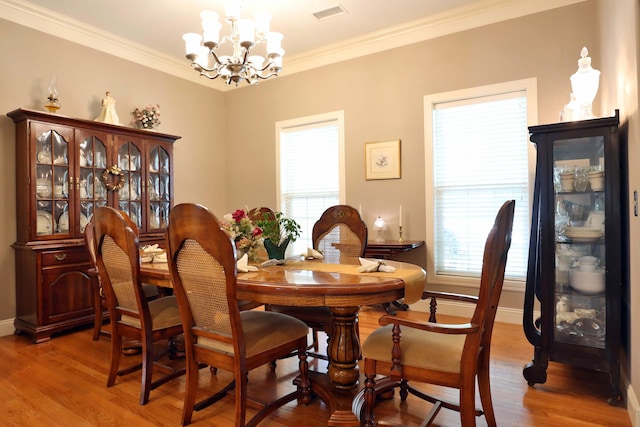 607 Sumac Ln, Marshfield, MO 65706 - dining space with a chandelier, plenty of natural light, light wood finished floors, ornamental molding, and baseboards