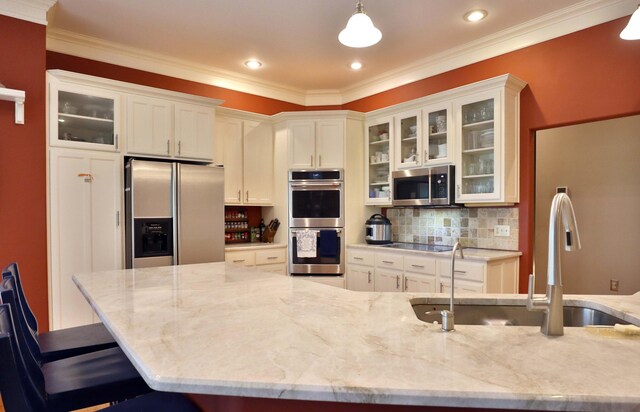607 Sumac Ln, Marshfield, MO 65706 - kitchen with appliances with stainless steel finishes, a sink, light stone counters, white cabinets, and crown molding
