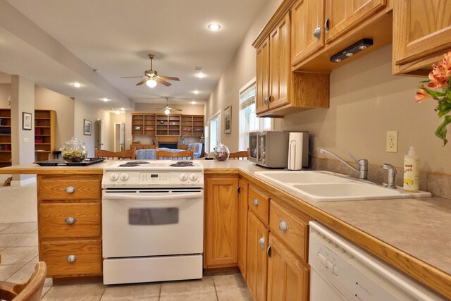 607 Sumac Ln, Marshfield, MO 65706 - kitchen with white appliances, a peninsula, a sink, ceiling fan, and light countertops