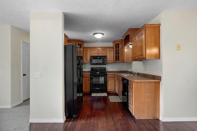 259 Aven Ave, Sparta, MO 65753 - kitchen featuring black appliances, brown cabinets, glass insert cabinets, dark wood-type flooring, and light countertops