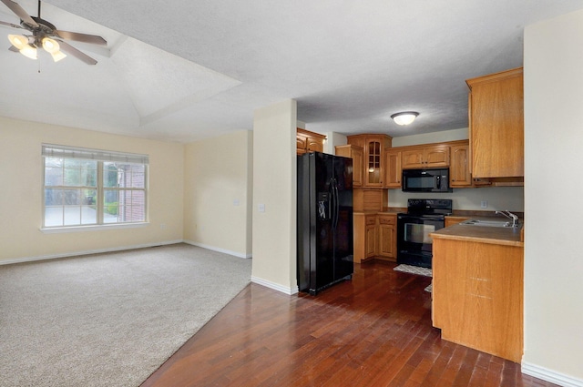 259 Aven Ave, Sparta, MO 65753 - kitchen with black appliances, dark wood-type flooring, brown cabinetry, glass insert cabinets, and ceiling fan