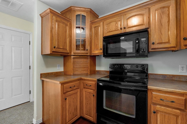 259 Aven Ave, Sparta, MO 65753 - kitchen with black appliances, glass insert cabinets, brown cabinetry, and light countertops