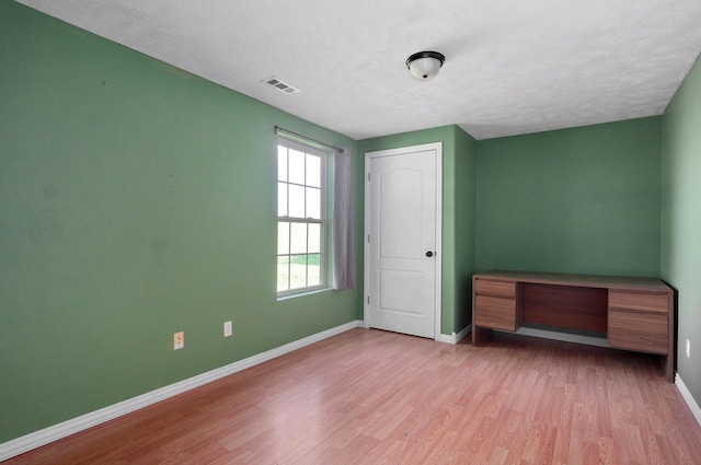 259 Aven Ave, Sparta, MO 65753 - unfurnished bedroom featuring wood finished floors and a textured ceiling