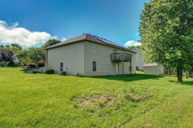 259 Aven Ave, Sparta, MO 65753 - rear view of house with a lawn, a storage unit, and a deck