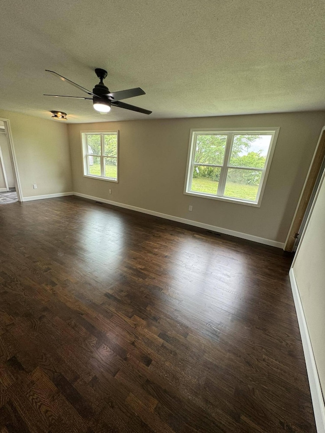 8574 County Road 6890, West Plains, MO 65775 - empty room with a textured ceiling, ceiling fan, dark wood-style floors, and baseboards
