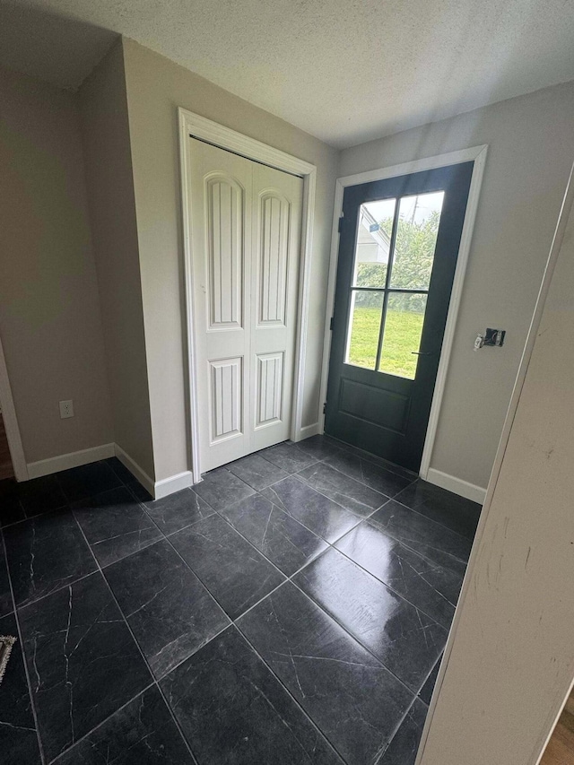 8574 County Road 6890, West Plains, MO 65775 - foyer entrance featuring baseboards and a textured ceiling