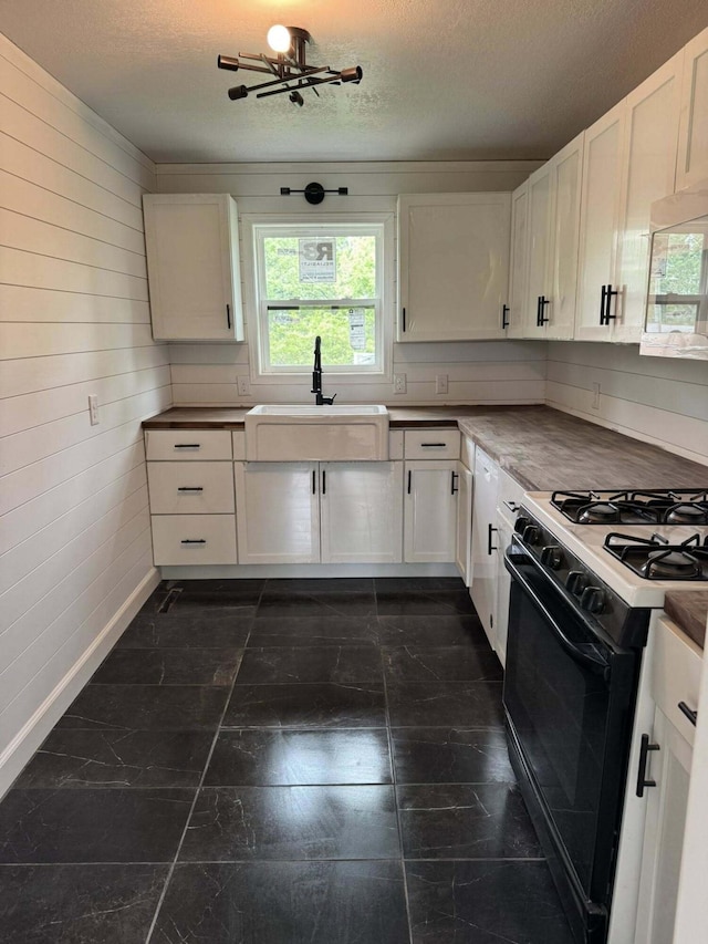 8574 County Road 6890, West Plains, MO 65775 - kitchen featuring gas stove, a sink, a textured ceiling, white cabinetry, and white microwave
