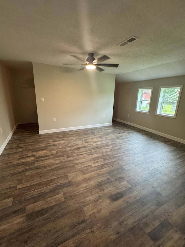 8574 County Road 6890, West Plains, MO 65775 - unfurnished room featuring dark wood-style flooring, ceiling fan, baseboards, and a textured ceiling