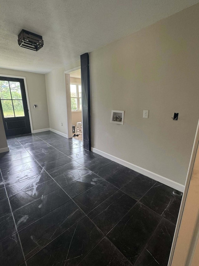 8574 County Road 6890, West Plains, MO 65775 - unfurnished room with plenty of natural light, baseboards, and a textured ceiling