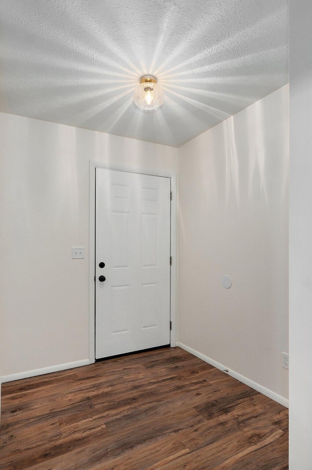 2411 S Rogers Ave, Springfield, MO 65804 - entryway featuring dark wood-style floors, baseboards, and a textured ceiling